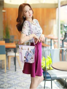 Detailed view of purple floral tote bag with chain strap and matching chic outfit
