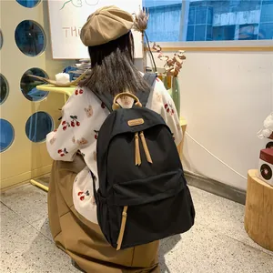Minimalist black large capacity nylon backpack with brown leather tags for daily use