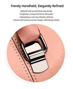 Detail of pink lychee leather handbag with silver metal buckle and contrast white stitching