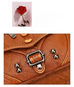 Detail of vintage brown pebbled leather texture with metallic studs and buckles