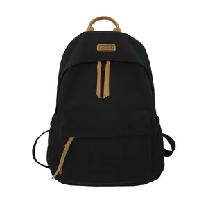 Minimalist large capacity black canvas backpack with brown leather accents for students