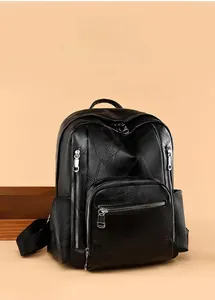 Close-up of black PU leather backpack with geometric stitching and silver zippers