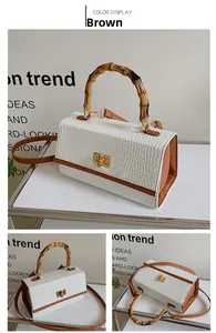 Vue détaillée d'un sac à main motif crocodile avec anse en bambou et fermoir doré