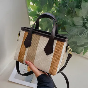 Bolso saco elegante de lona a rayas para mujer con ribete de cuero marrón y oro