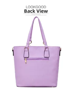 Back view of lavender purple leather tote bag showing rear zipper pocket and golden hardware