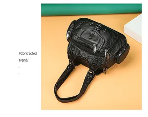 Close-up of black washed leather handbag featuring multi-pocket design and metal rivets