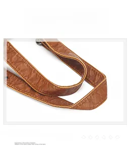 Detail of ergonomic brown vintage leather handle with premium stitching and texture