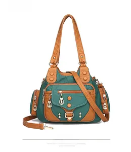 Close-up of green and tan pebbled faux leather texture and metallic hardware details