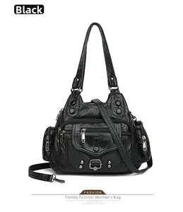 Detail view of black washed PU leather handbag with multiple pockets and silver zippers