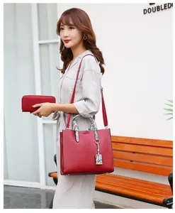 Detailed shot of red crocodile texture tote bag and matching long zipper wallet on a model