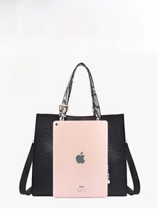 Macro shot showing large capacity interior of black crocodile embossed tote bag with iPad