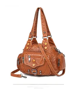 Close-up of vintage brown washed PU leather handbag with multiple functional zip pockets
