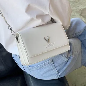 Sac bandoulière blanc pour femme avec boucle cerf argentée et bandoulière chaîne