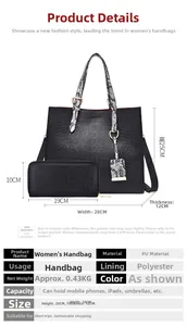 Detail view of black crocodile pattern tote bag set with snake print handles and tassel