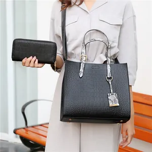 Elegant black crocodile-pattern tote bag set with snakeskin handles and matching wallet