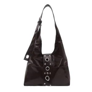 Dark burgundy Y2K style hobo shoulder bag with silver eyelet rivets and glossy finish