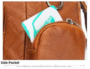 Detail of caramel brown pebbled leather handbag featuring a functional side zipper pocket