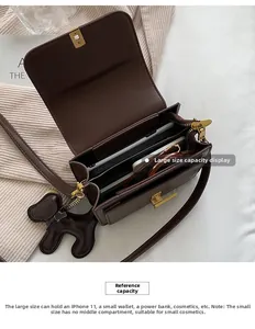 Détail de la capacité interne du sac à bandoulière carré marron avec compartiments