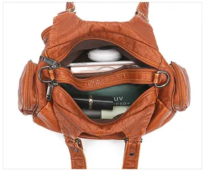 Top view of multi-pocket vintage brown tote showing spacious interior compartments