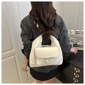Detail of minimalist beige faux leather tote bag with functional front buckle pocket