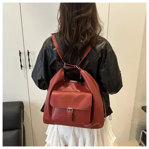 Deep red leather tote bag with silver hardware shown on a model for a vintage look