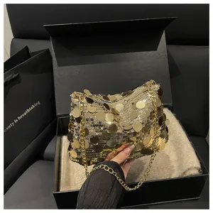 Macro detail of gold sequins and elegant metal chain on a luxury women crossbody bag