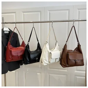 Detailed row of large tote bags in red, black, white, and brown showing front pockets