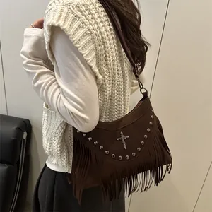 Brown suede crossbody bag with metallic rivets and long tassels in bohemian style