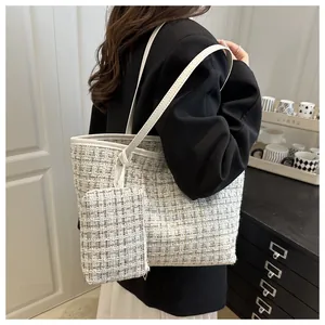 Tweed tote bag with matching coin purse and white leather straps shown on a model