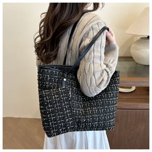 Detail of tweed tote bag and matching coin purse with premium textured fabric finish
