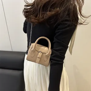 Minimalist beige mini handbag with vintage buckle and elegant metal chain strap for women