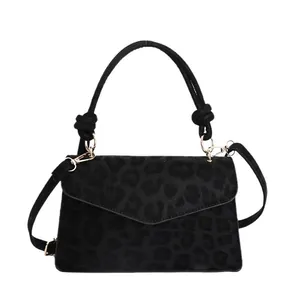 Elegant vintage black leopard print small crossbody bag with knotted handle and gold hardware