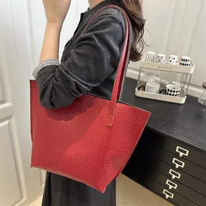 Large red crocodile pattern tote bag for women shown on shoulder in daily scene