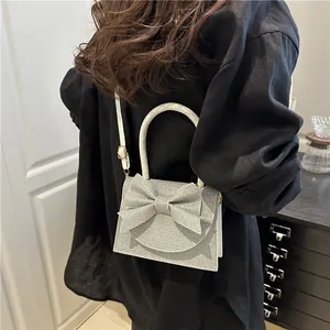 Silver sequin mini square handbag with bow accent and white pearl-style handle for women