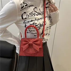 Sparkly red glitter crossbody bag with large bow and pearl handle for women