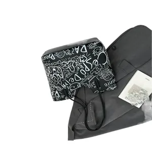 Large black tote bag with white graffiti patterns and stylish thin shoulder straps