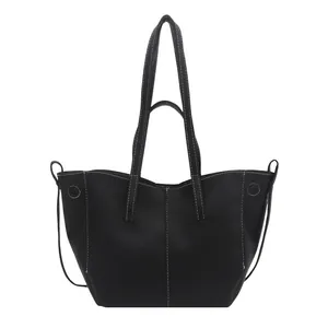 Schwarze Tote-Bag aus genarbtem Leder mit weißen Kontrastnähten und langen Henkeln