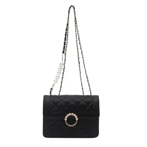 Elegant black quilted crossbody bag with pearl strap and diamond lattice texture
