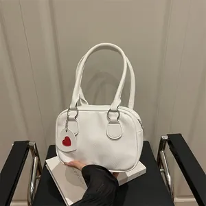 Borsa bowling bianca con grana litchi e ciondolo a cuore per uno stile moderno