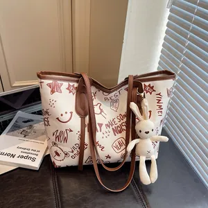 Chic off-white contrast tote bag with brown cartoon graffiti and plush bunny charm