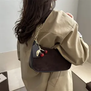 Retro chocolate brown crescent crescent bag with suede texture and cherry charm accessory