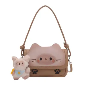 Cute cartoon cat-shaped crossbody bag in khaki and pink with plush charm accessory