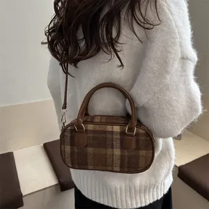 Brown plaid woolen boston bag with vintage leather handles and gold metal zipper hardware
