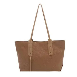 Brown woven tote bag with long shoulder straps and large capacity for daily use