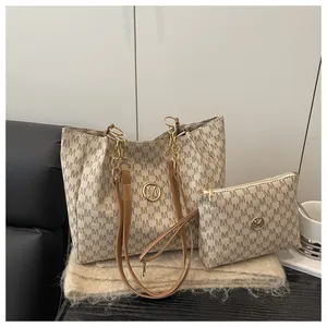 Détail du sac cabas à monogramme avec pochette assortie et logo M doré sur fausse fourrure