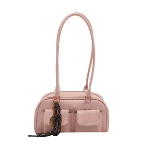 Minimalist light pink shoulder bag with dual front pockets and tennis racket charm