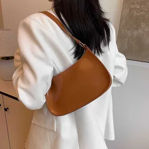 Minimalist brown PU leather underarm bag with sleek silhouette and polished finish