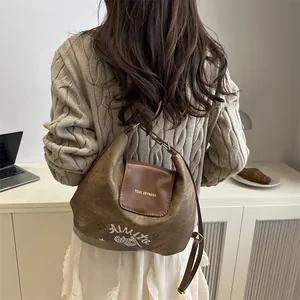Dark brown faux leather crescent bag with Amour print and adjustable shoulder strap