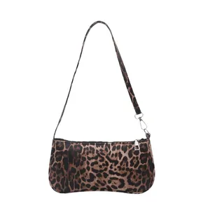 Vintage leopard print shoulder bag with silver zipper and slim strap on white background