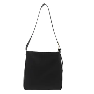 Minimalist black leather bucket bag with large capacity and adjustable shoulder strap